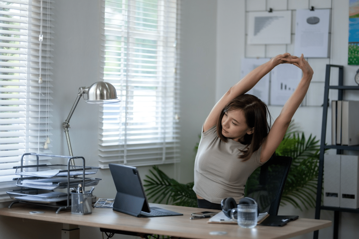 Hydrated lady stretching after drinking from bottled water cooler